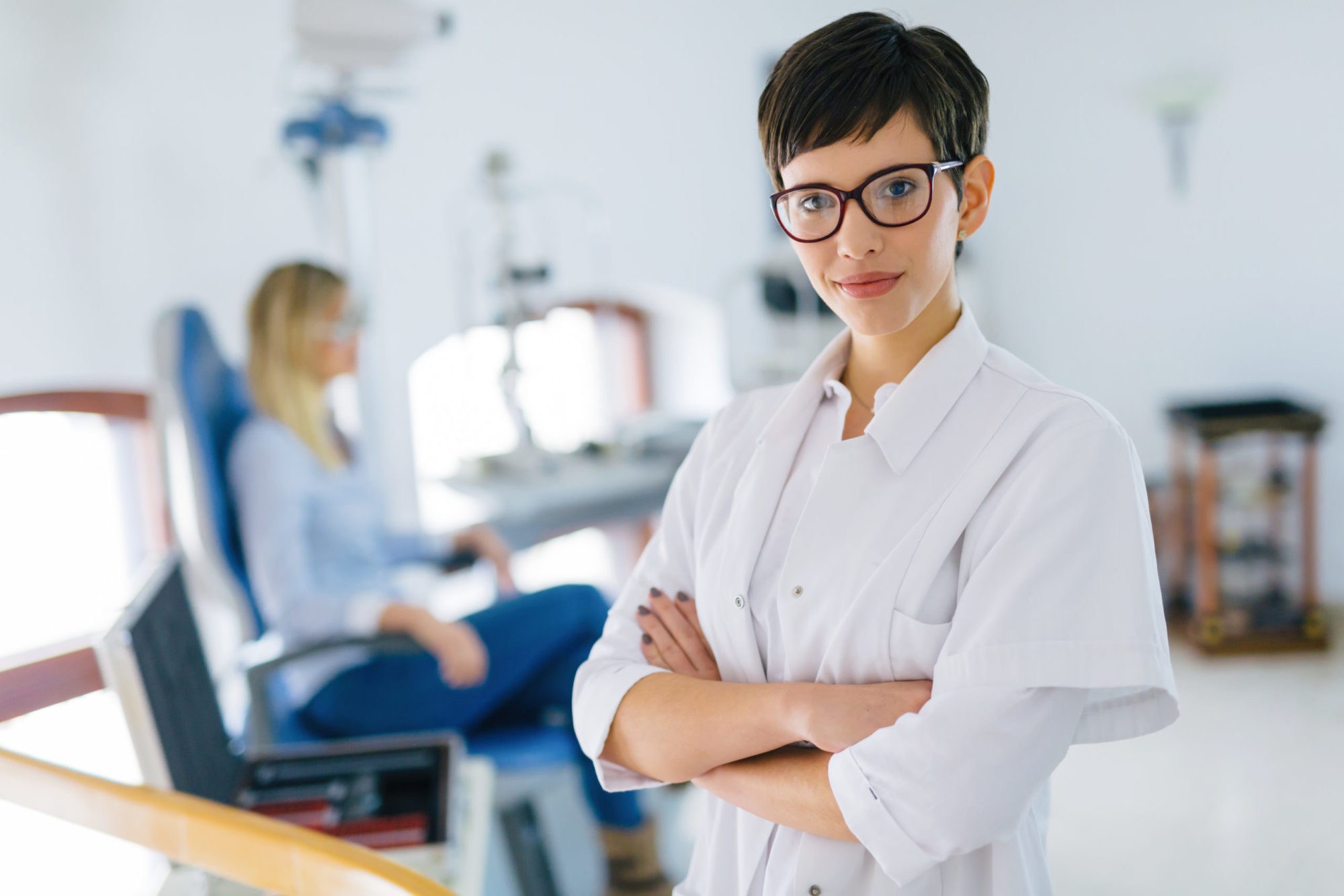 Beautiful Young Ophthalmologist In Clinic Beautiful young ophthalmologist doctor in eyesight clinic